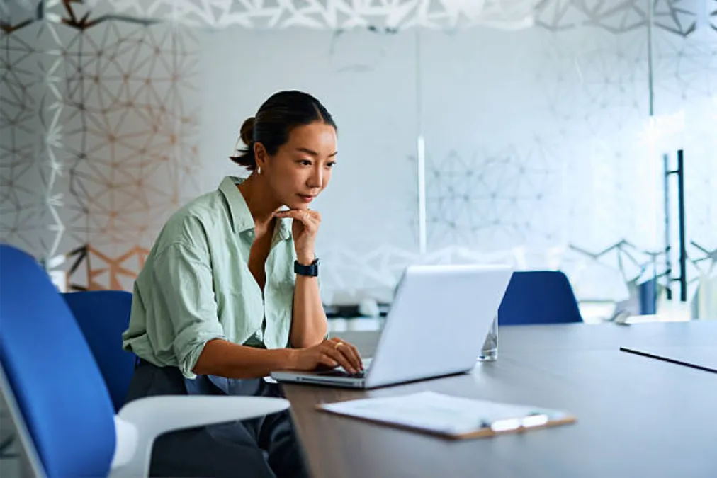 Businesswoman working on laptop in modern office