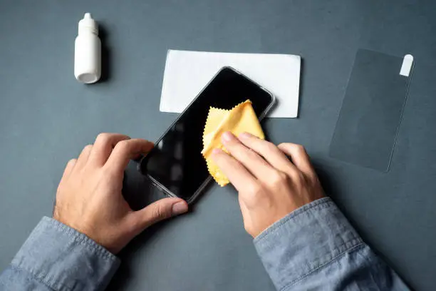 Man cleaning the phone display