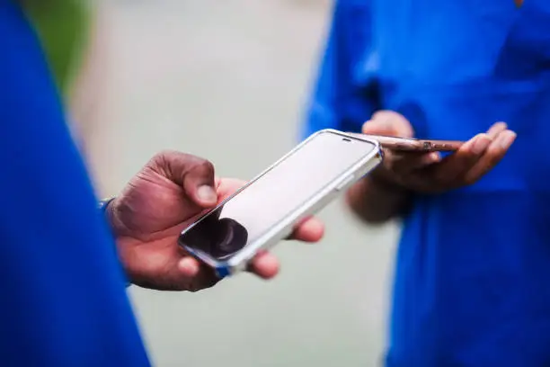 Two-people-in-scrubs-using-mobile-phones