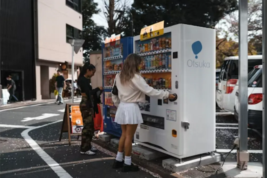 a-woman-standing-next-to-a-vending-machine