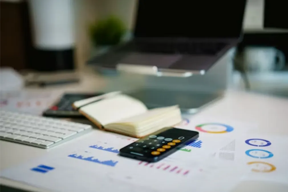office-desk-with-smartphone-and-financial-charts_1779096859